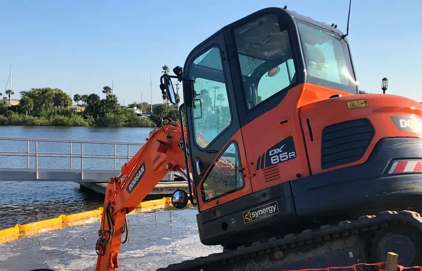 Marine construction equipment working near the shoreline during foundation and piling work in Florida